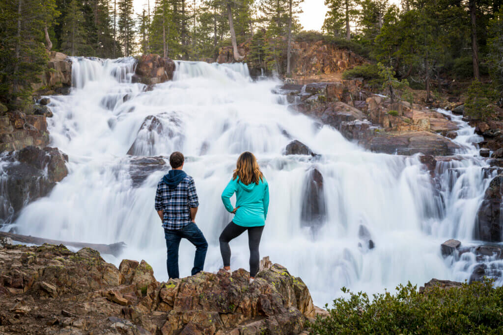 two people standing in front of eagle falls at Lake TAhoe