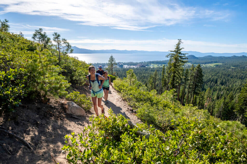 a group of people hiking at lake tahoe on the tahoe rim trail