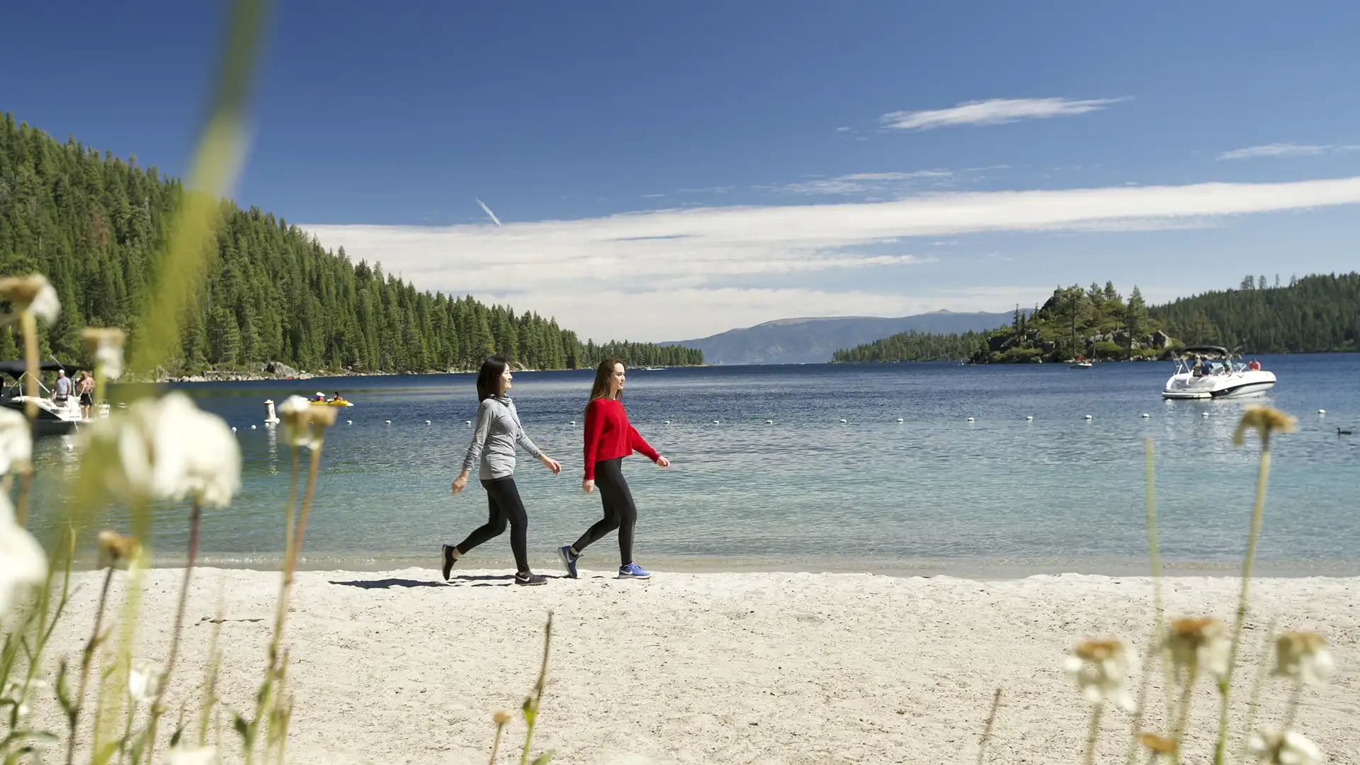 Two women walking Emerald Bay Beach Lake Tahoe